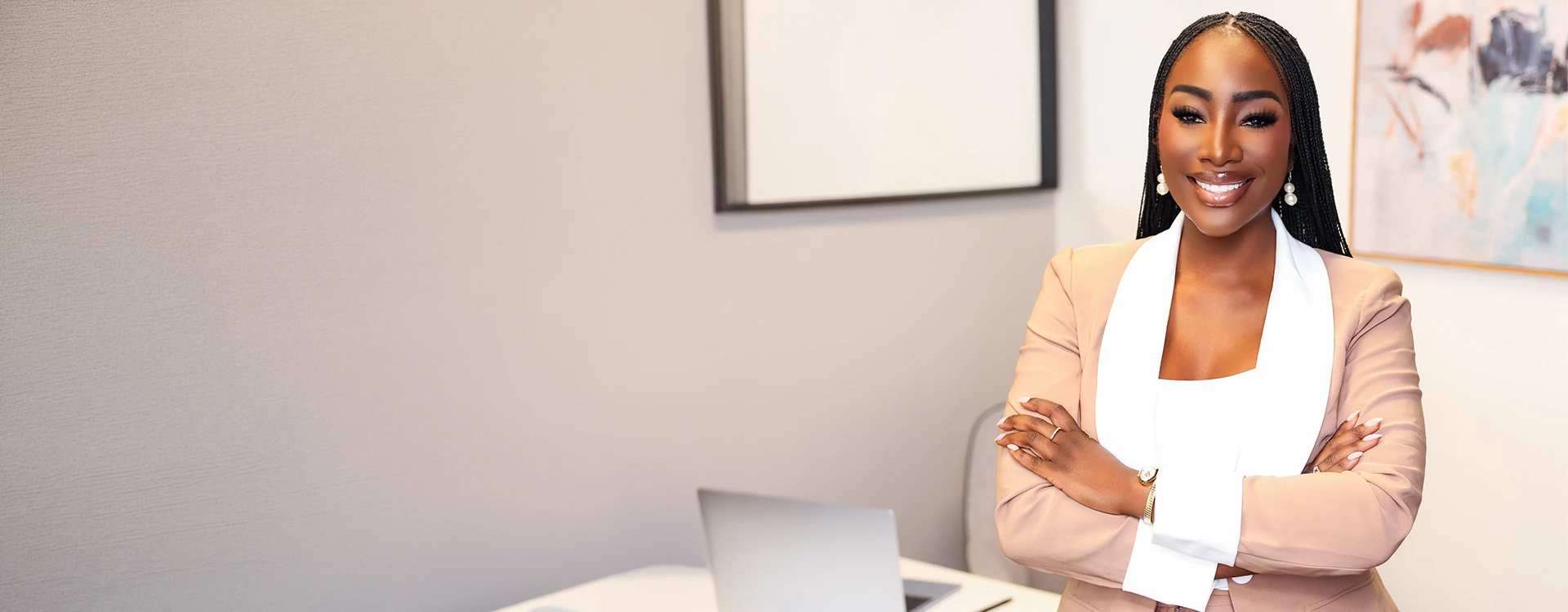 Confident attorney standing in a modern office with arms crossed and a professional demeanor.